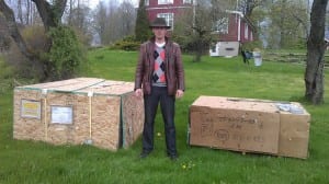 Customer posing with his Growing Dome greenhouse shipping crates