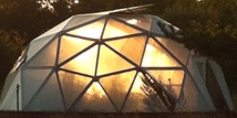 geodesic dome greenhouse at sunset