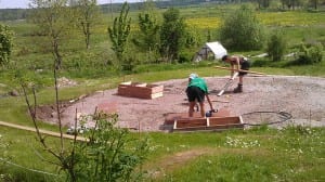 Crew members laying out the foundation wall sections for a Growing Dome greenhouse