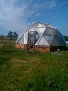 22' Growing Dome Greenhouse at Green Angel Gardens in Long Beach, WA during a blue sky day. 