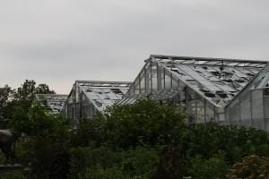broken glass greenhouse after hail storm