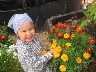 girl with flowers inside Growing Dome