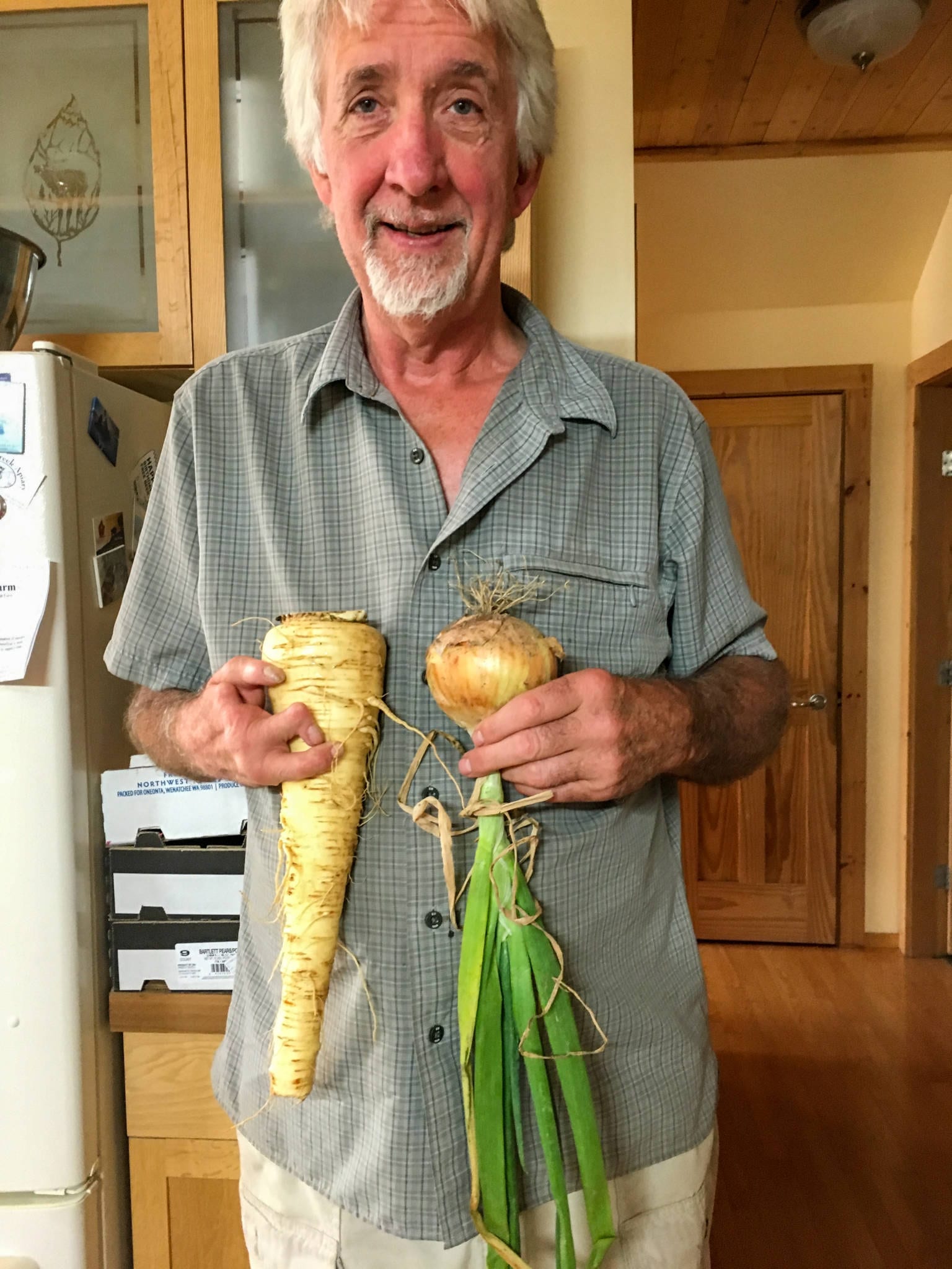 Man holding organic fresh grown ingredients from his backyard kitchen garden