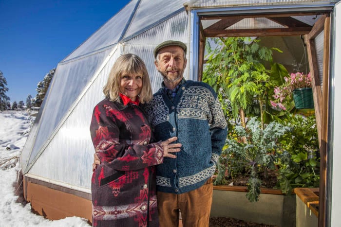 puja and Udgar in front of a 26' Growing Dome Greenhouse