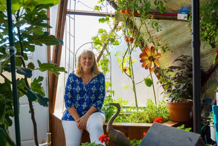 Caroline Swank in her custom greenhouse