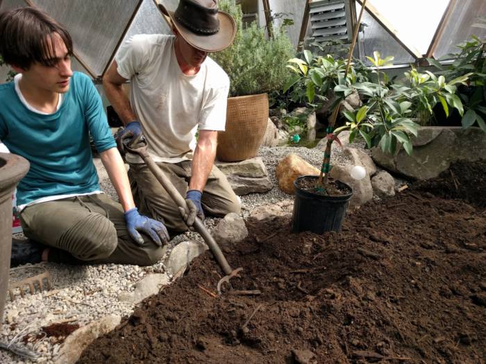 digging soil in biodome greenhouse