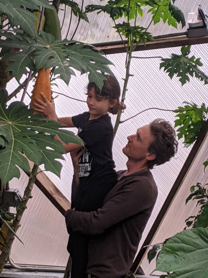 Jack Comstock and his son in the tropical greenhouse