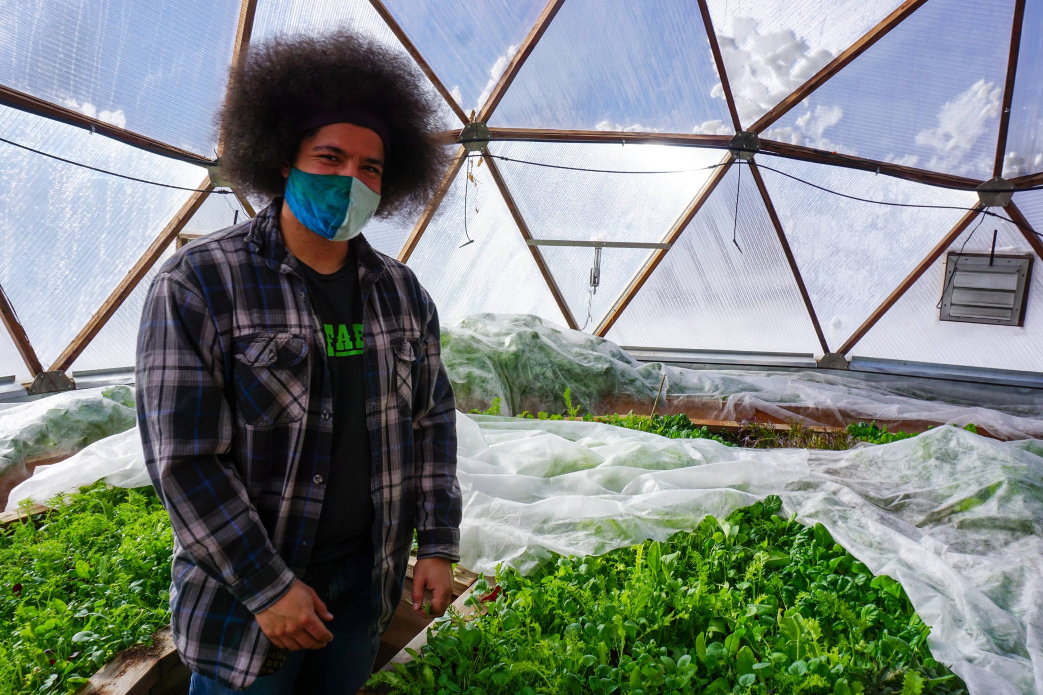Malik Salsberry in a Growing Dome Greenhouse