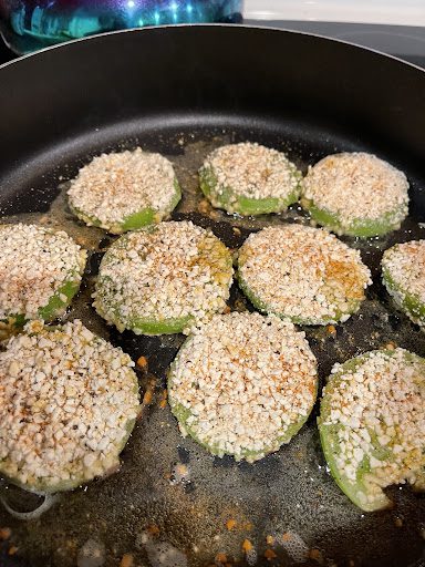 frying green tomatoes in a cast iron skillet