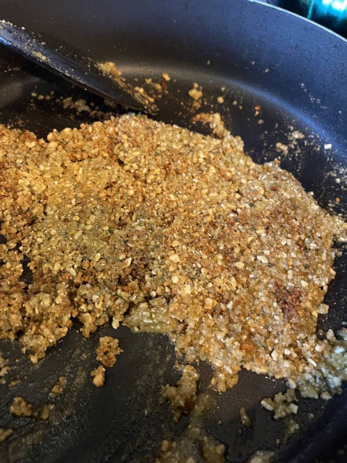 cooking bread crumb mixture on stovetop