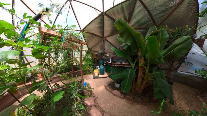 tropical climate battery greenhouse with pond.
