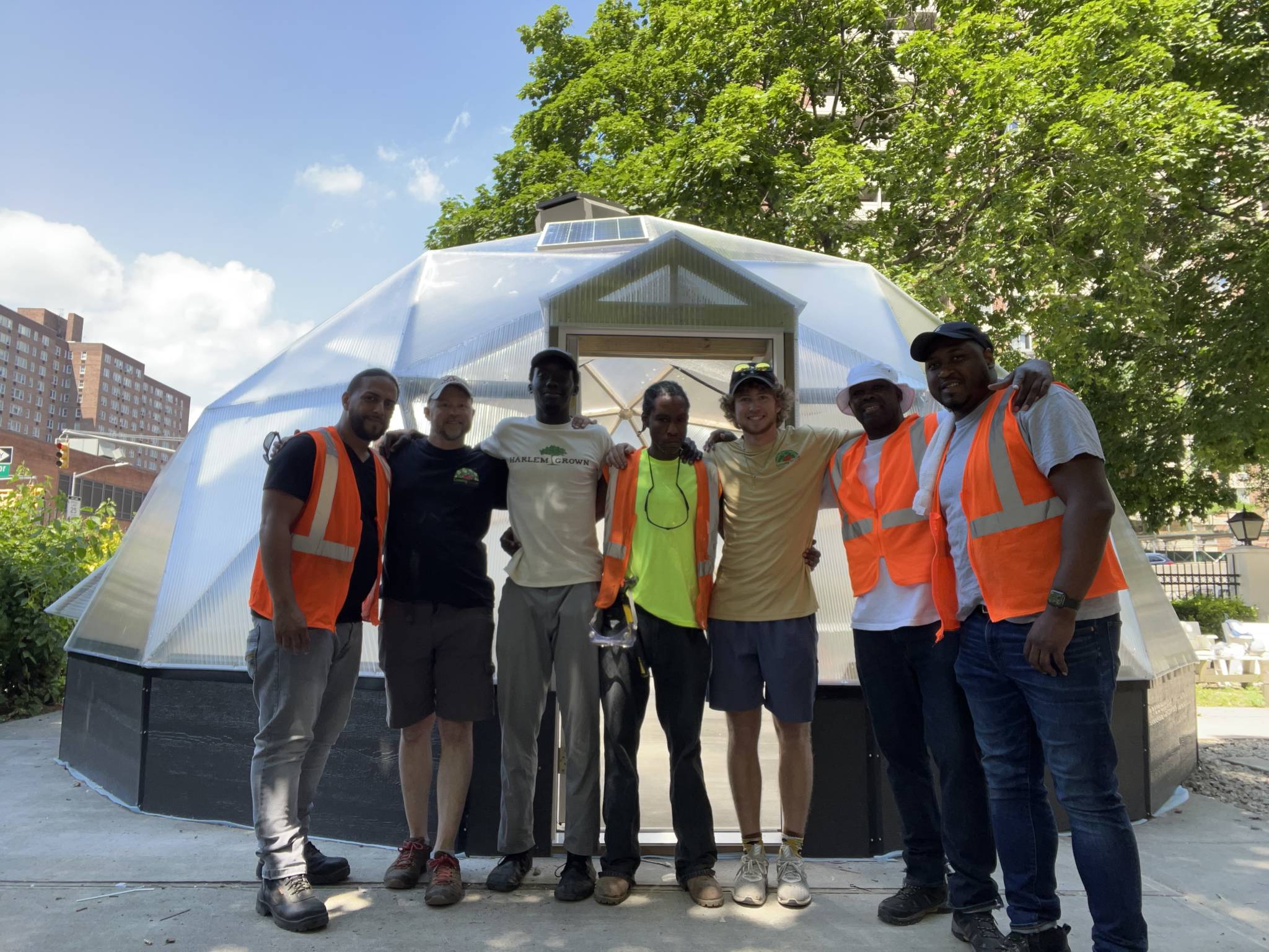 community members pictured in front of Urban Greenhouse being built in Harlem