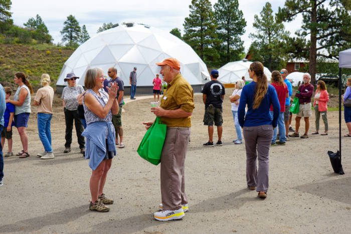 Growing Dome owners mingling at the customer appreciation event with the 42' and 33' Growing Domes in the background.