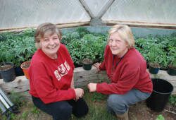 two women (barbra and danielle) inside a growing dome greenhouse garden 
