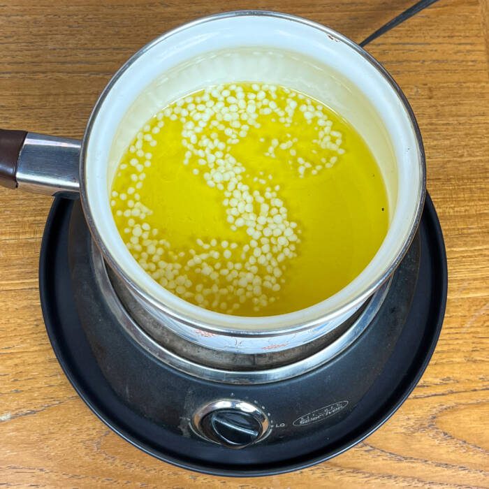 Melt beeswax and calendula oil