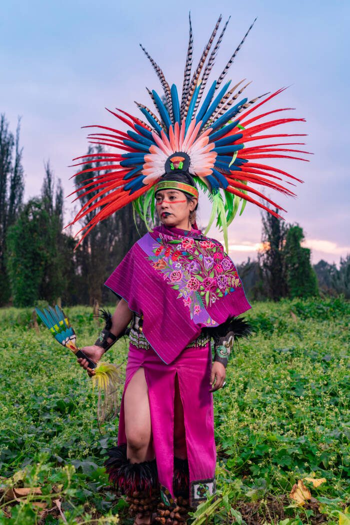 Aztec dancer in a field also known as "Chinampa" in Xochimilco, Mexico, wearing the traditional Aztec clothing